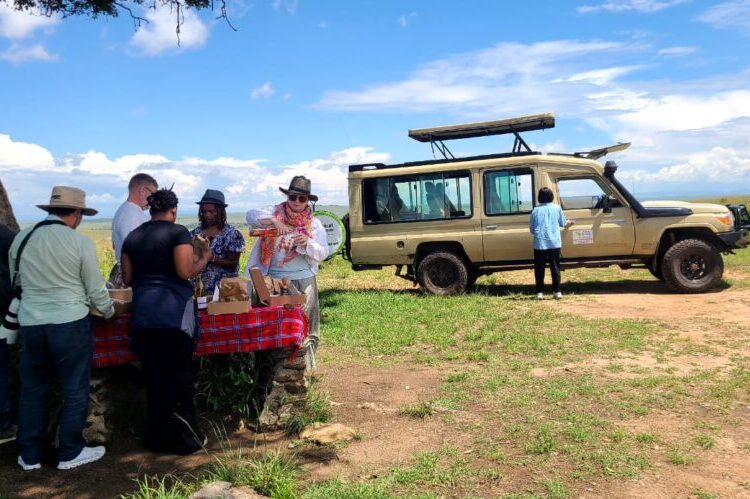 Picnicking tourists in the Masai Mara on a Tsavo East Tsavo West Amboseli budget safari in Kenya