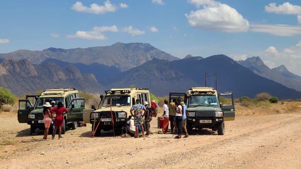 Off-the-Beaten-Track Safari Adventure in Remote Kenya Three safari Land Cruisers in a remote Kenyan desert with clients taking a break during an off-the-beaten-track safari adventure