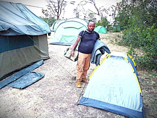 Client preparing to enter a mobile tent on a 30-Day Epic Kenya Mobile Camping Expedition